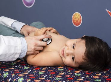 close-up-baby-being-examined-with-stethoscope-min