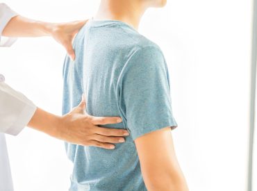 close-up-physiotherapist-working-with-patient-clinic-min