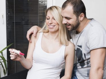 woman-husband-looking-pregnancy-test-min